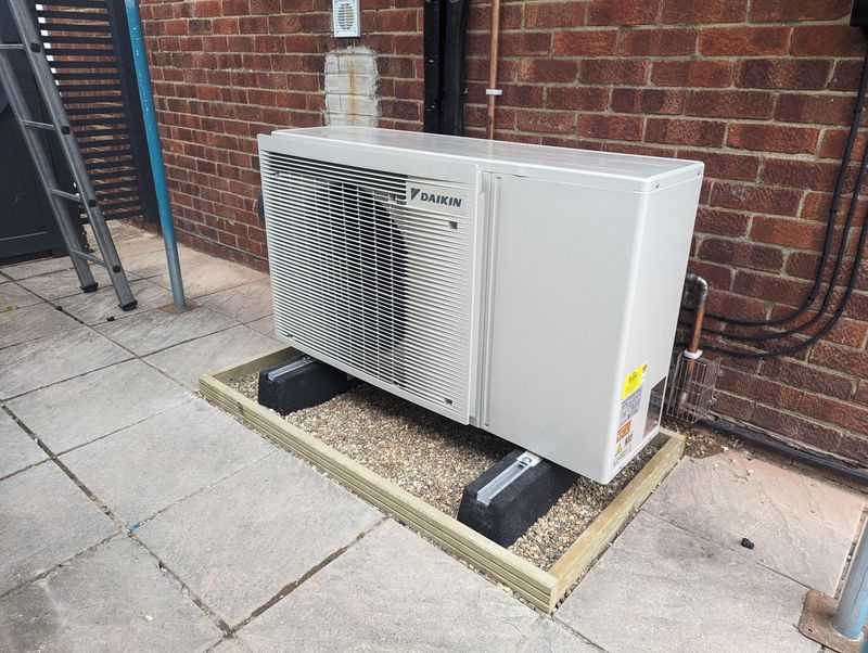 Daikin Air Source Heat Pump outdoor unit on timber-framed gravel plinth with anti-vibration mounts — Smith EcoFlow heat pump repair completed