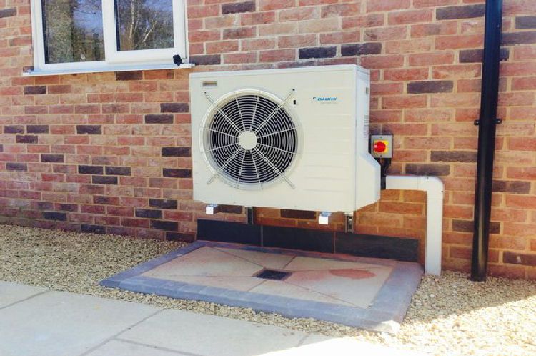Daikin Altherma Air Source Heat Pump outdoor unit on raised plinth with tidy condensate run and isolator — Smith EcoFlow ASHP service installation
