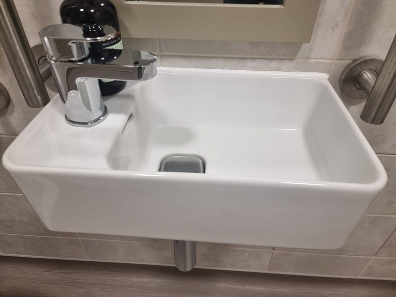 DDA-compliant disabled access wall-hung wash basin with single-lever lever-handle mixer tap — Smith EcoFlow accessibility plumbing installation