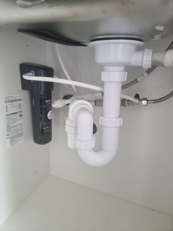 Under-sink water filter system installed alongside new kitchen sink waste pipework, P-trap and isolation valves — Smith EcoFlow domestic plumbing installation